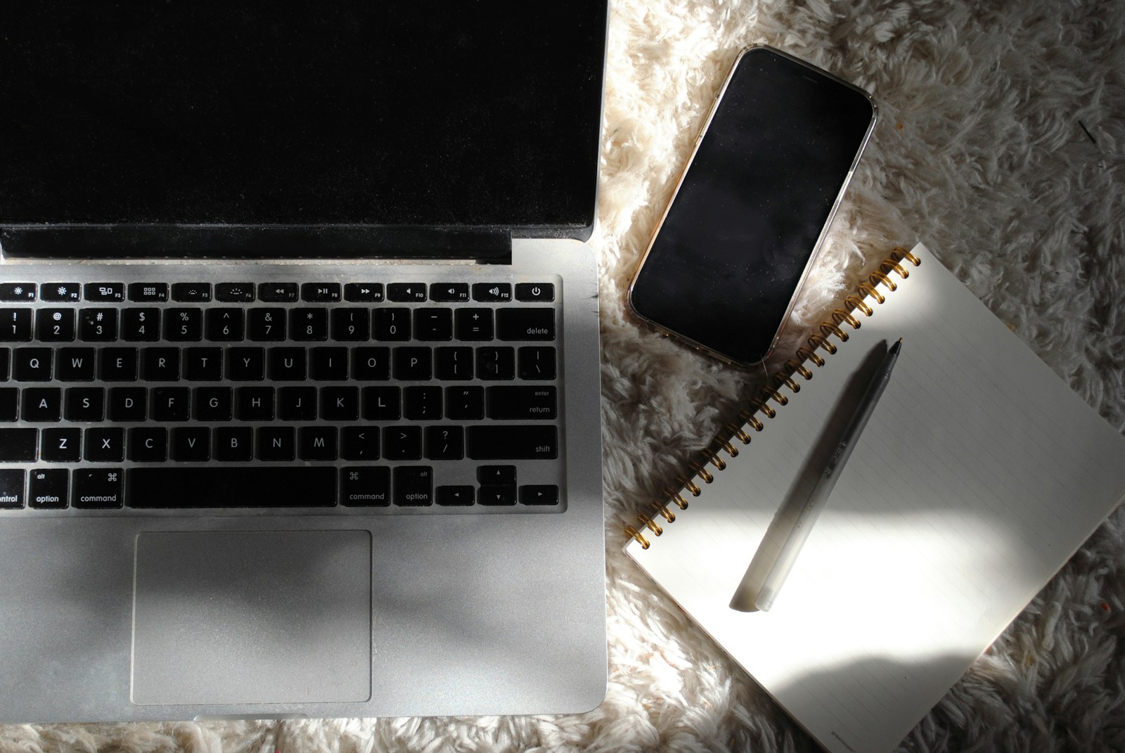 an open laptop computer sitting on top of a white rug